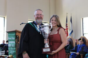 Dean Stebbins giving an award to representative from Phi Mu sorority