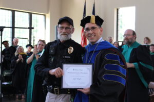 Jeff Shaffer accepting an award with President Caridi