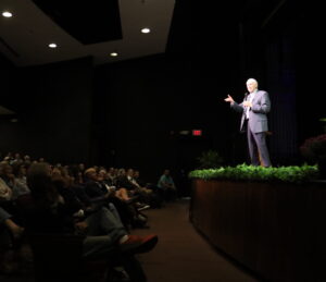 Dave Wottle on stage speaking to audience